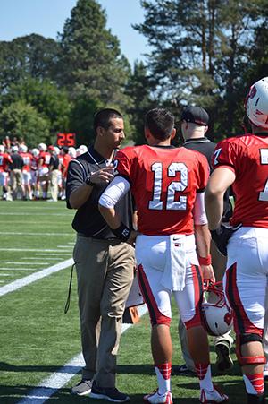 Helmets to Headsets: Young alumni return to coach