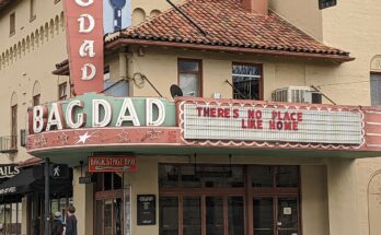Bagdad Theater entrance and sign, with channel lettering stating "THERES NO PLACE LIKE HOME"